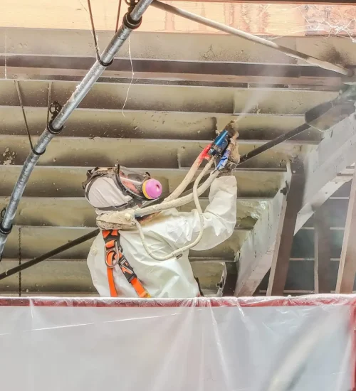 Certified insulation specialist carefully applying high-performance polyurethane spray foam to a structure.